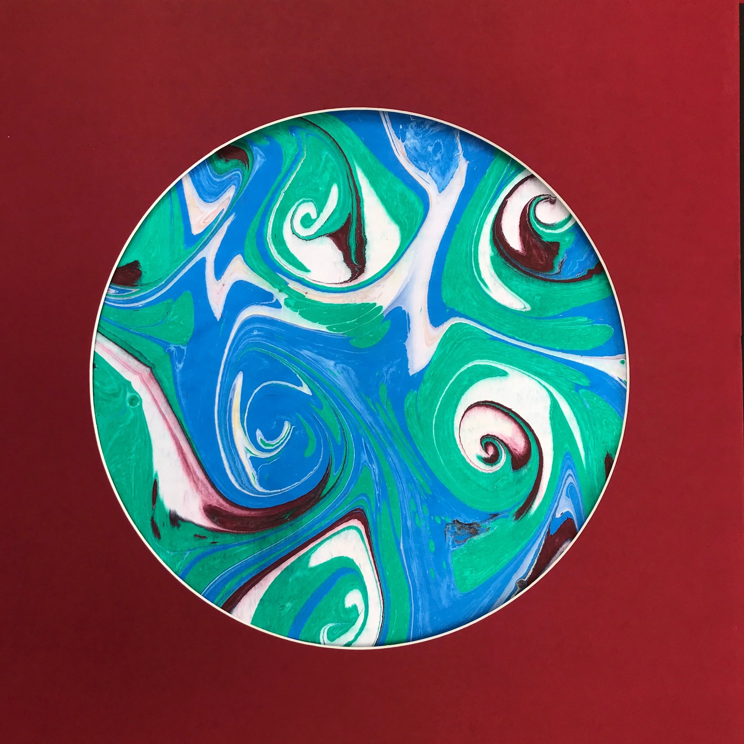 Green Marbled Moon print, the marbled disc of green and blue swirls shown on a deep red ground