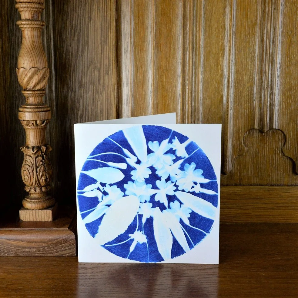 Spring is Early greetings card standing on a wooden mantelpiece