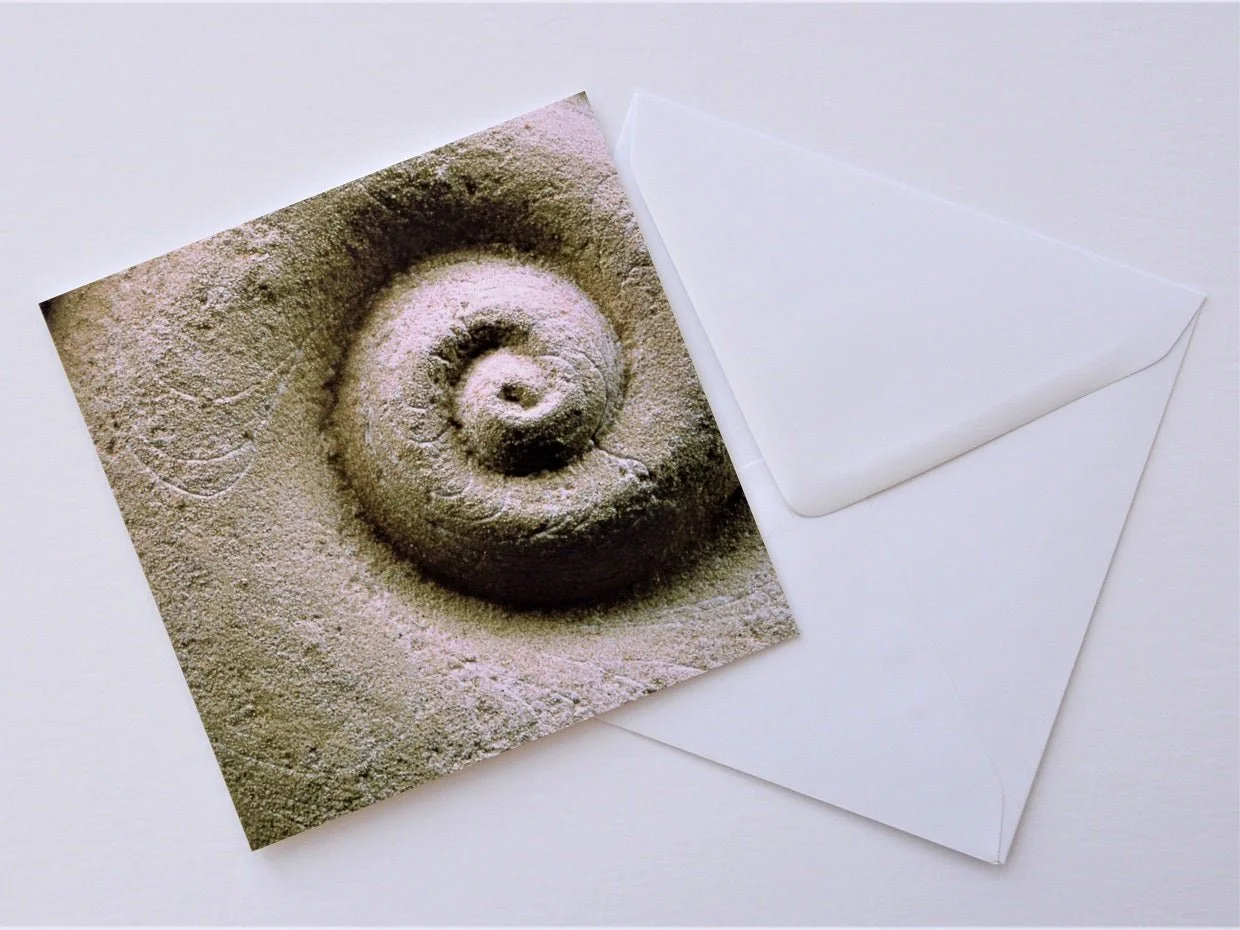 Spiralmoon greetings card shown at an angle with its white envelope