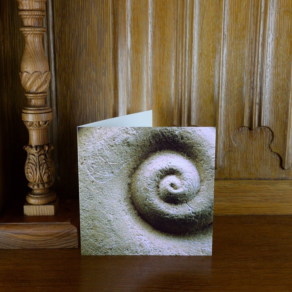 Spiralmoon greetings card standing on a wooden mantelpiece