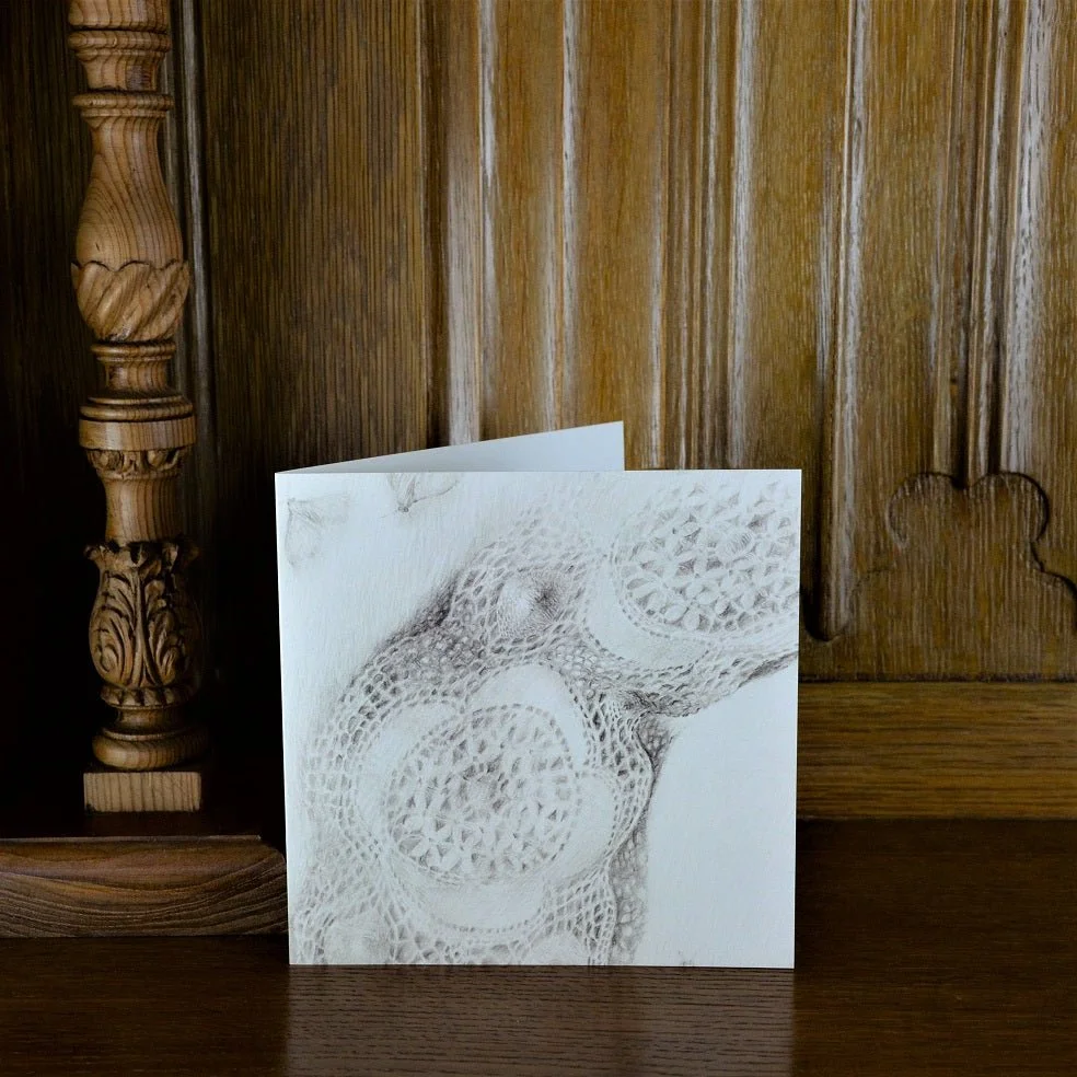Lace Moth Shadows greetings card standing on a wooden mantelpiece
