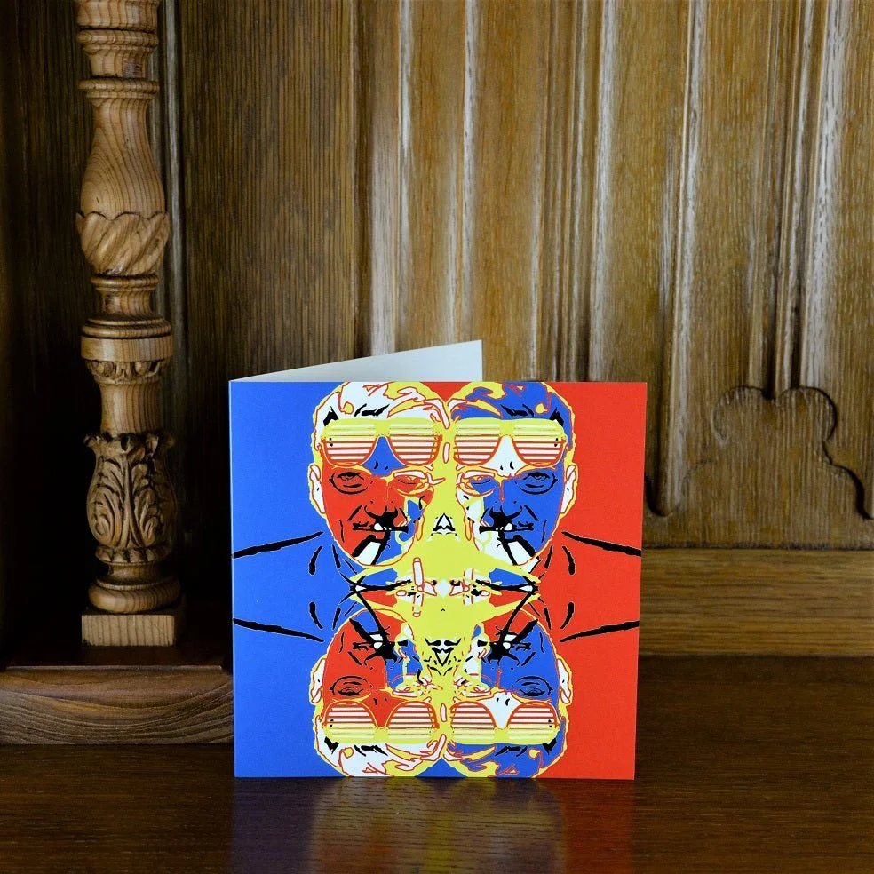Glass Man greetings card standing on a wooden mantelpiece