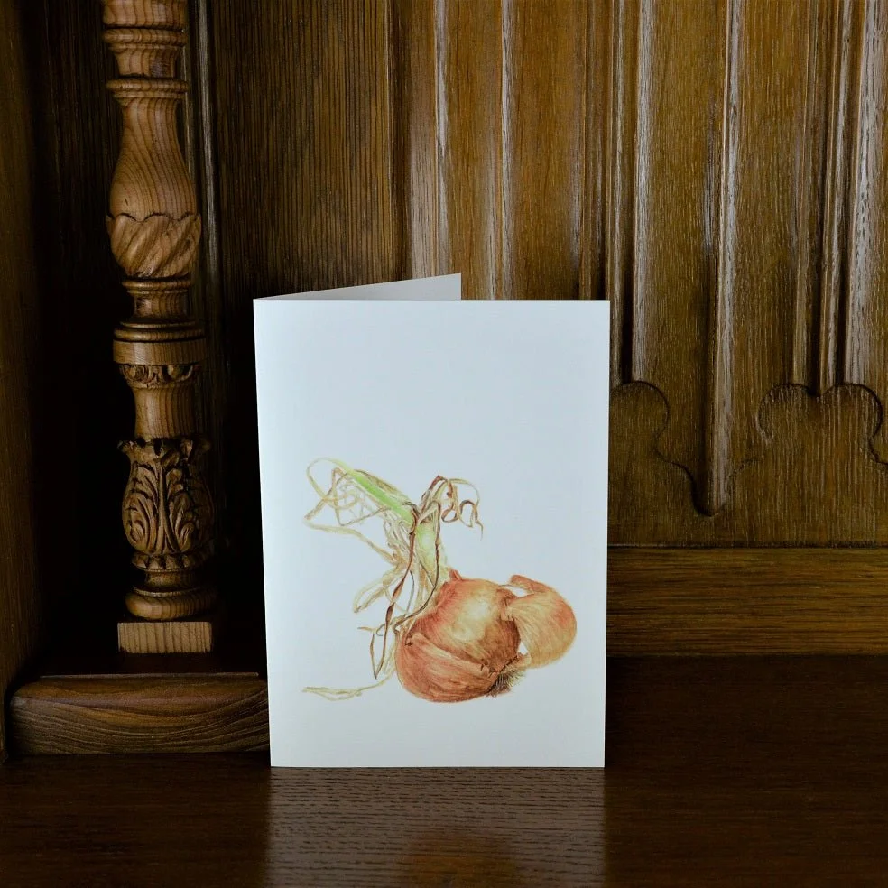 Sprouting Onion Shell vertical greetings card standing on a wooden mantelpiece