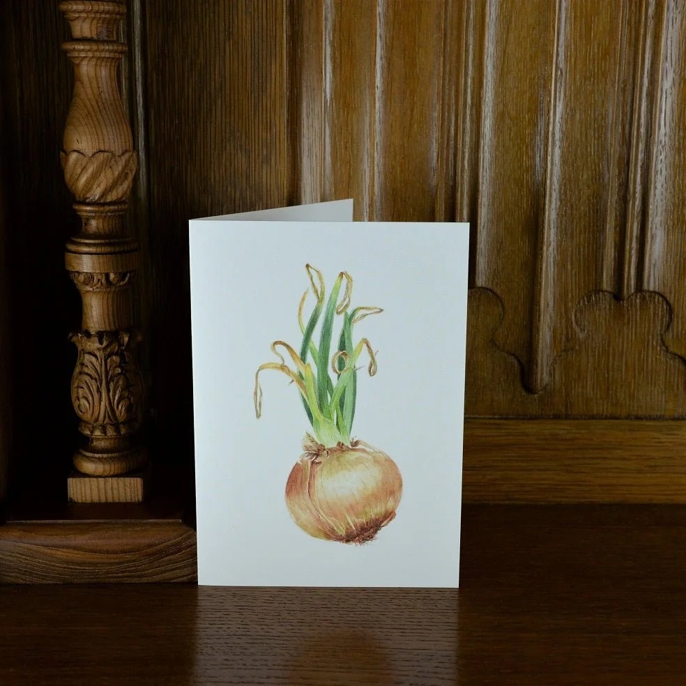 Sprouting Onion Green vertical greetings card standing on a wooden mantelpiece