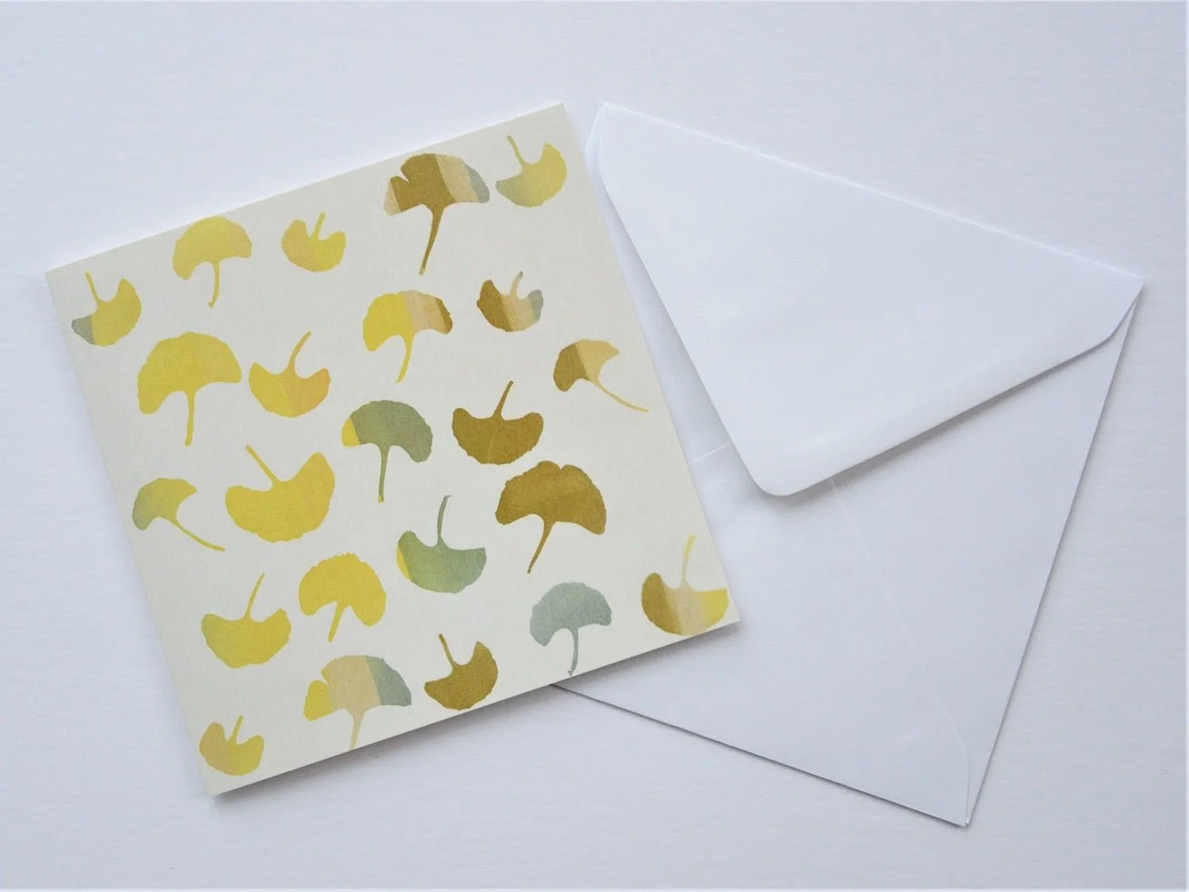 Ginkgo Autumn greetings card shown at an angle with its white envelope