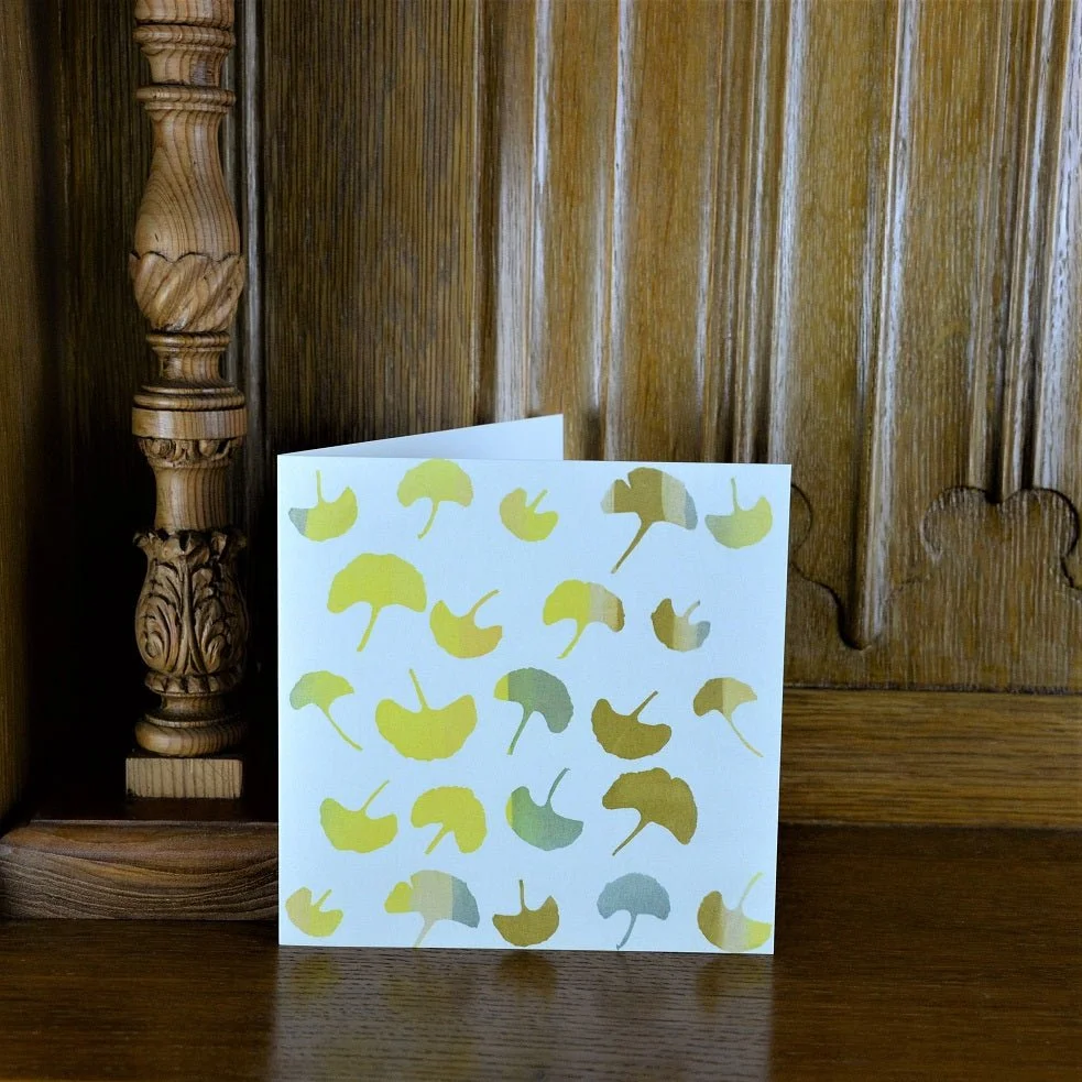 Ginkgo Autumn greetings card standing on a wooden mantelpiece