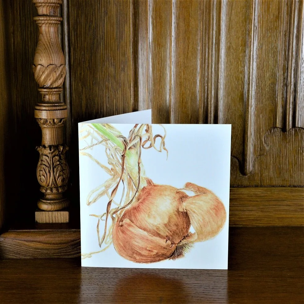 Sprouting Onion Shell greetings card standing on a wooden mantelpiece