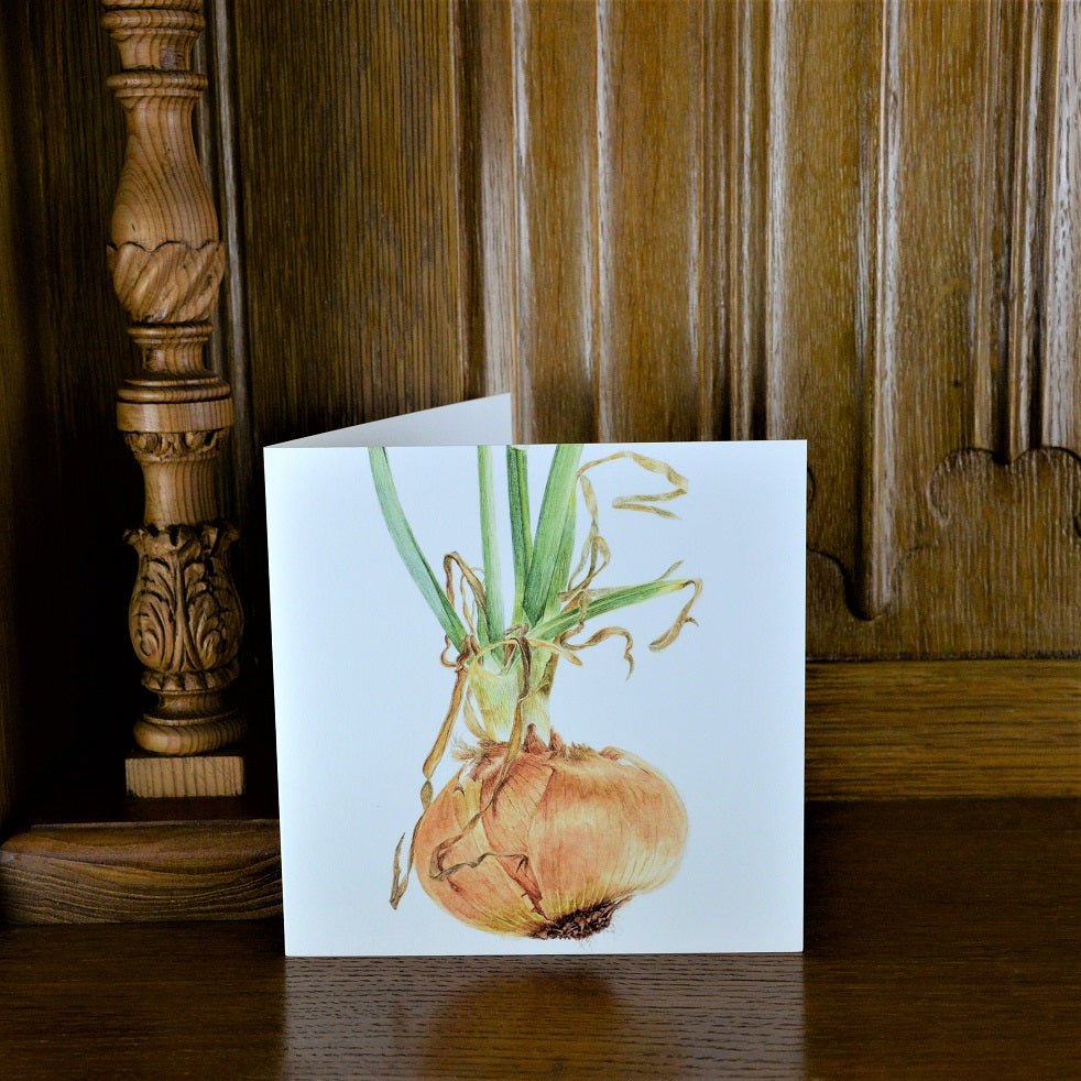 Sprouting Onion Beauty greetings card standing on a wooden mantelpiece