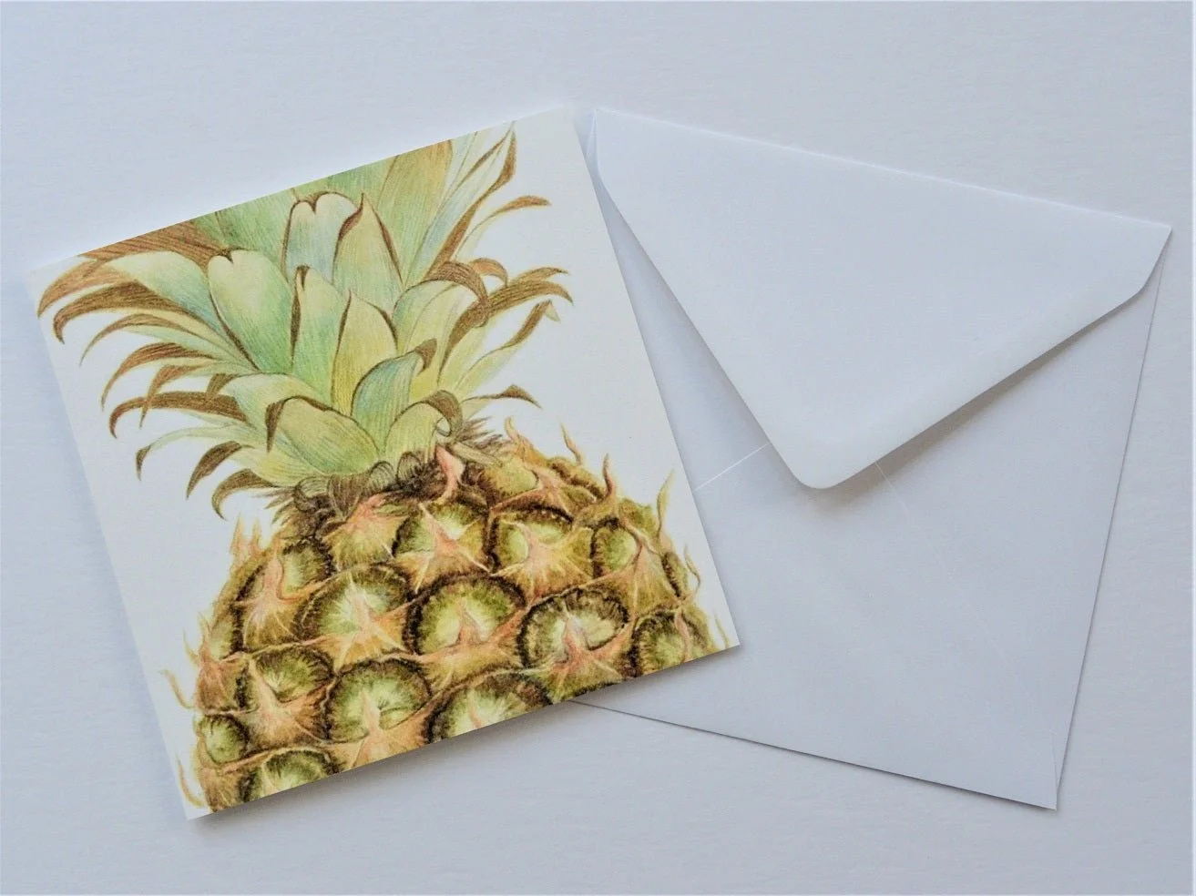 Pineapple Portrait greetings card shown at an angle with its white envelope