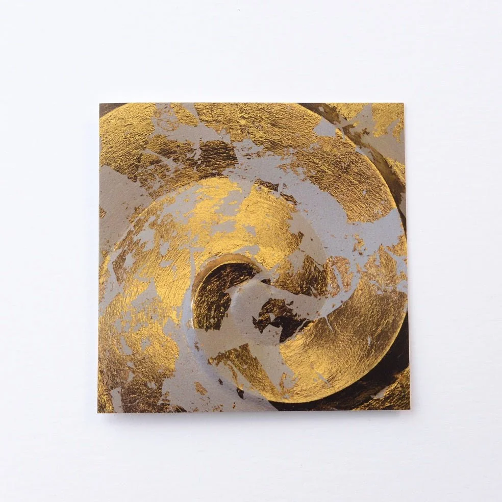 Golden Spiral greetings card, a photograph of the gold-leaf spiral wall sculpture