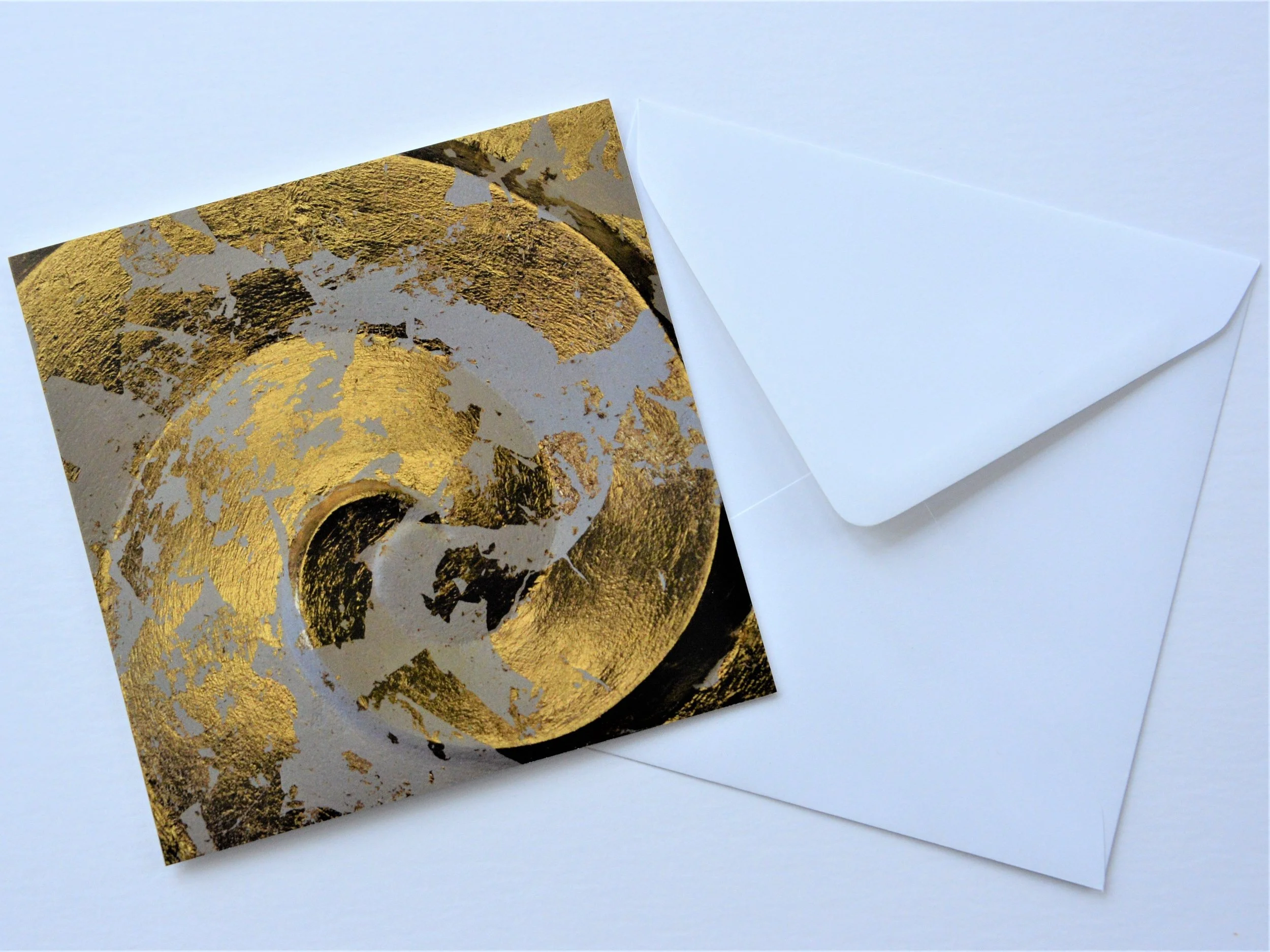 Golden Spiral greetings card shown at an angle with its white envelope