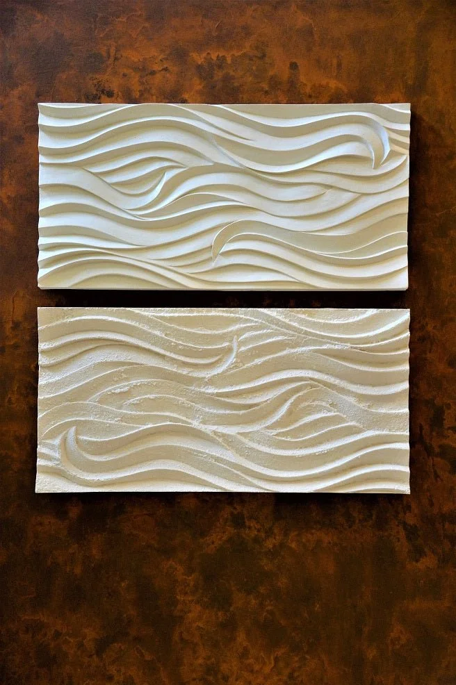 Smooth Sand Ripple wall sculpture, two rippled panels hung one above the other against a rust coloured ground