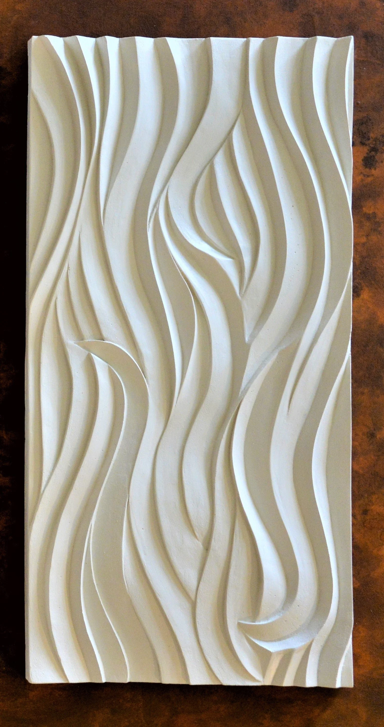 Smooth Sand Ripple wall sculpture, a tall panel of softly carved flowing ripples framed against dark timber