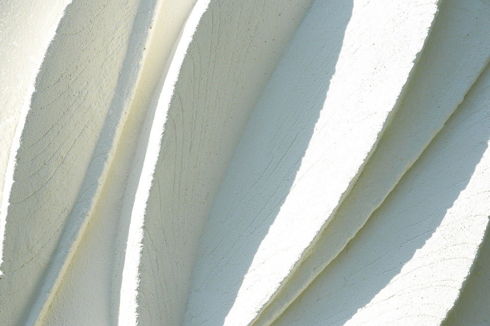 Close detail of the Two Leaf Forms wall sculpture showing the crisp edges of the carved leaf blades