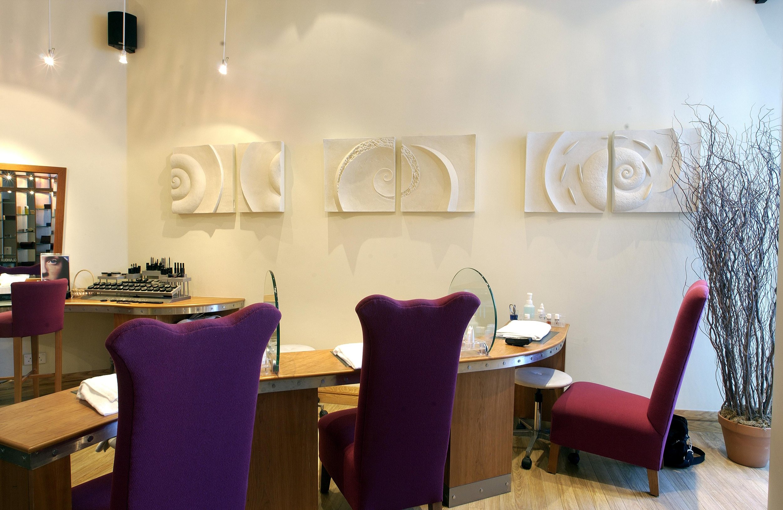 Spiralfish Wave and Tide panels displayed along the wall of a boardroom above a table with purple chairs