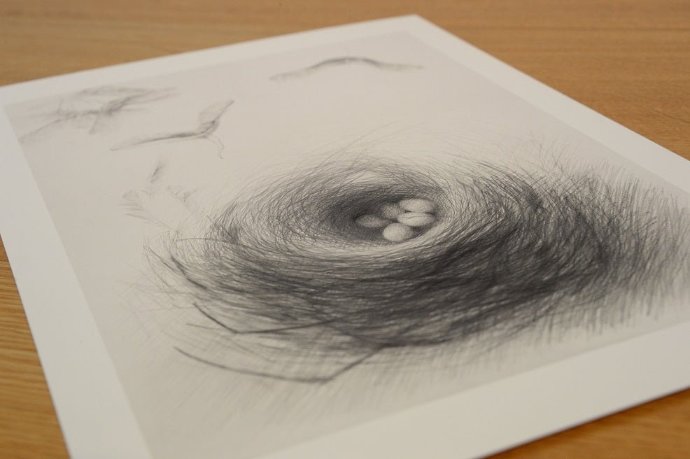 The Nested Sycamore Seeds Have Two Wings print lying at an angle on a wooden table