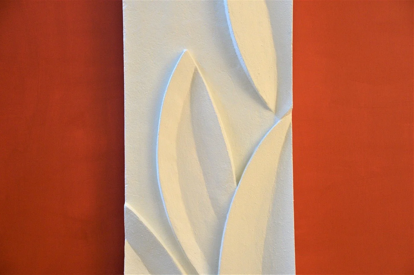 Close detail of the Magnolia Leaves wall sculpture showing how the carved leaf blades overlap