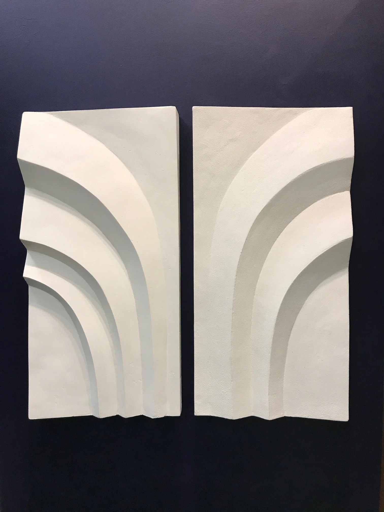 Two Palms wall sculpture, two white stone-finish panels of fanned arch reliefs shown on a dark ground