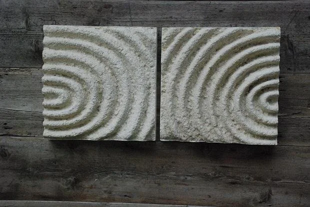 Echo Pattern wall sculpture, two panels of concentric carved ripples in a grey stone finish on weathered wood