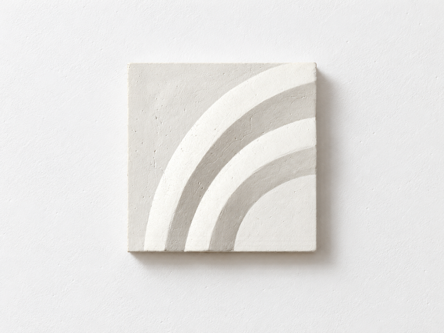White Acanthus Two Leaves relief with three curved bands against a white background.
