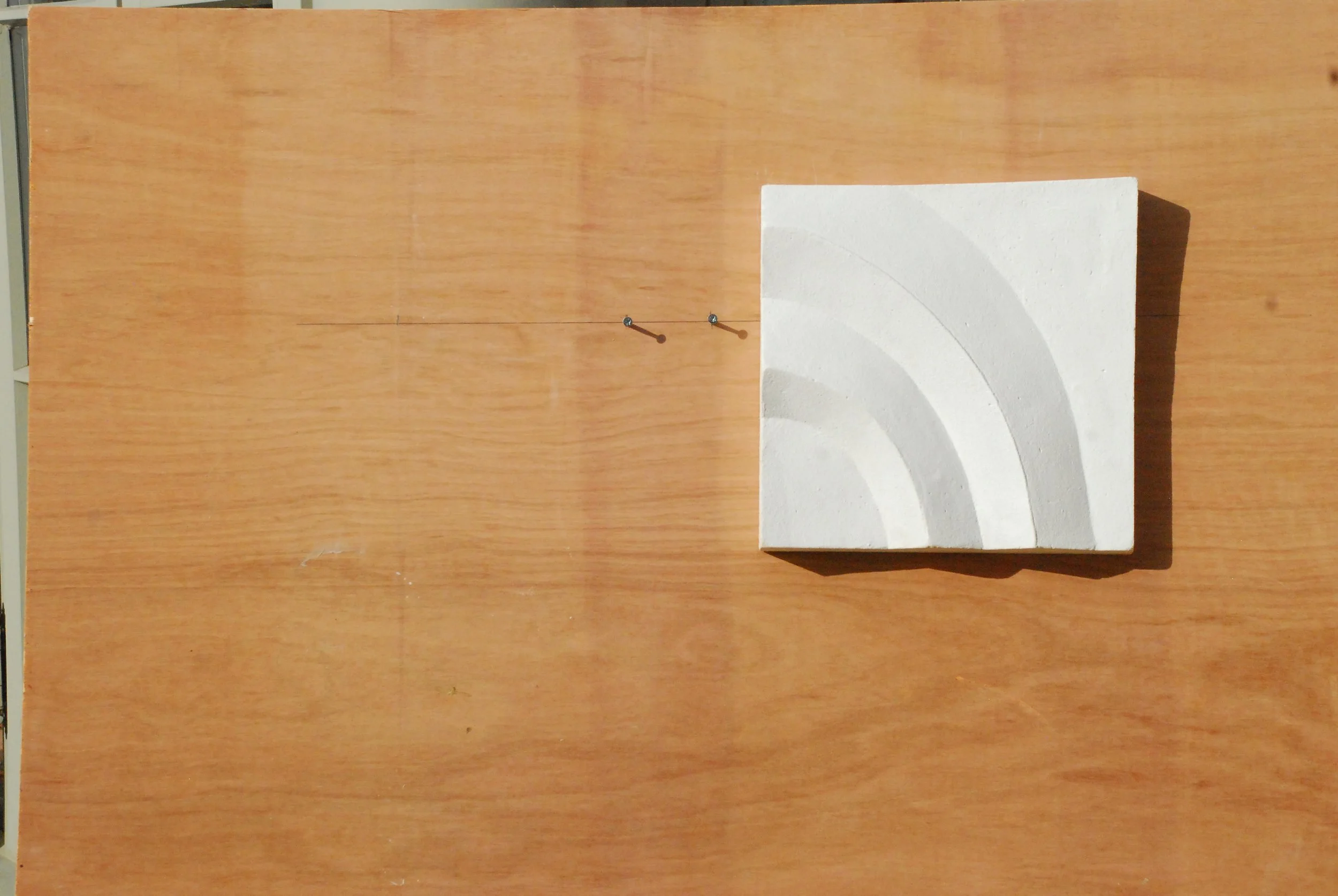 White Acanthus Two Leaves relief with curved bands rising to the left, displayed on timber.