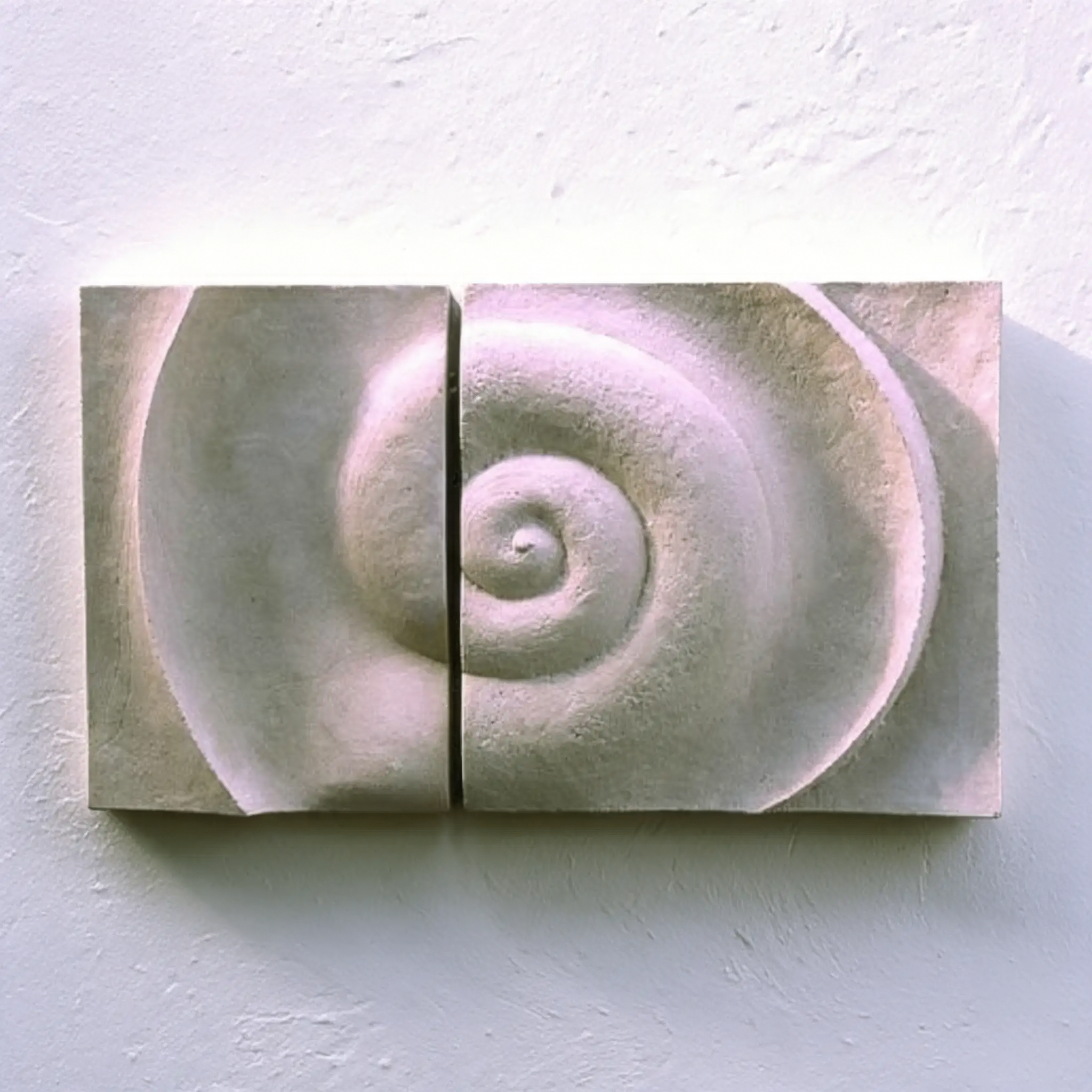 Two white Bone Spiral panels against a pale wall, showing a continuous spiral across both panels.