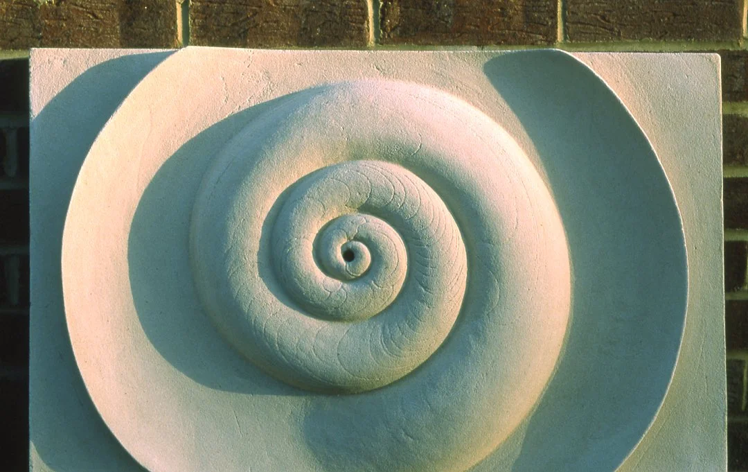 White Bone Water Spiral relief, showing the large spiral and smooth outer crescent.