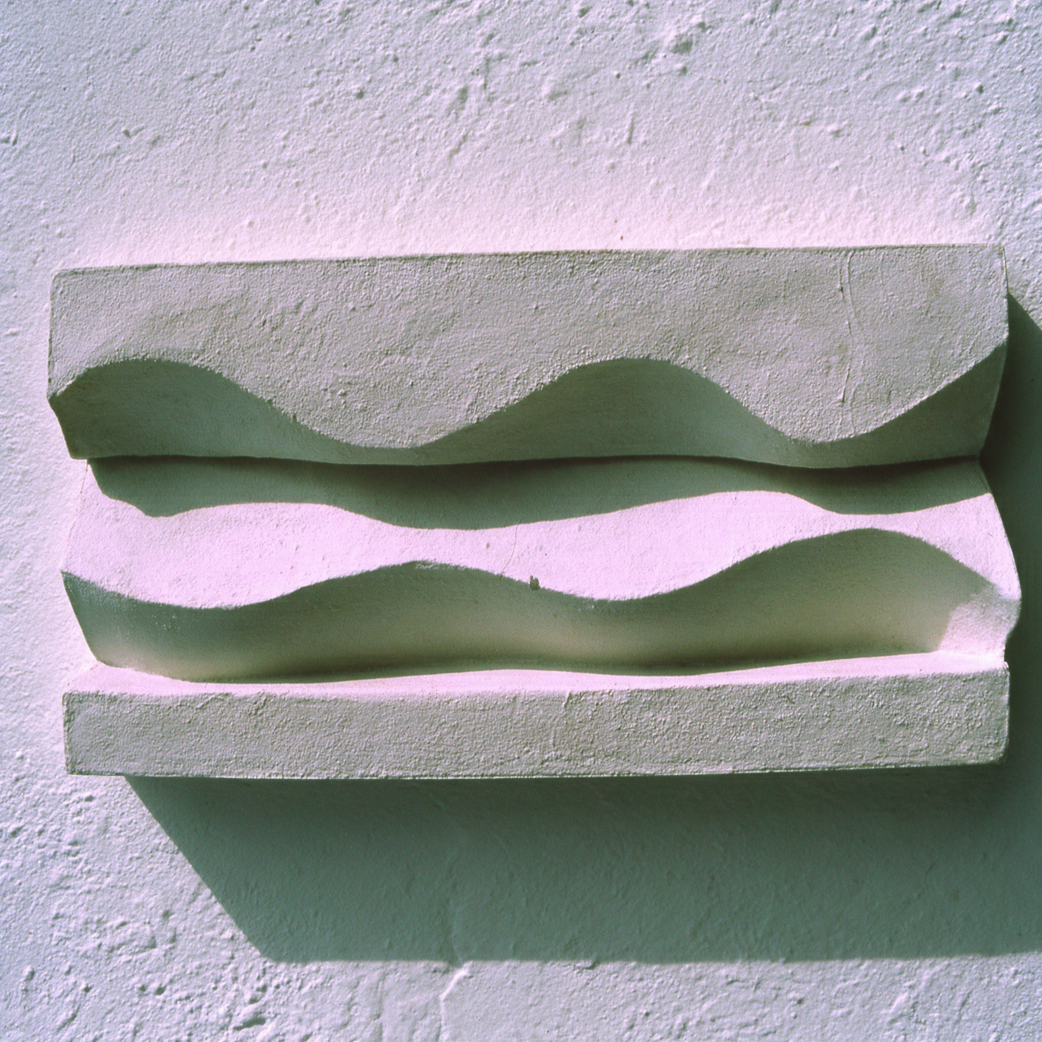 White Brancusi 1 relief displayed horizontally, with deep wave-shaped shadows.