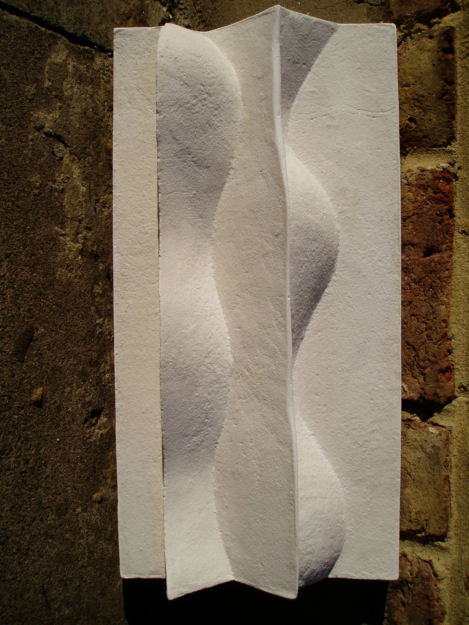 Front view of the white Brancusi 2 panel, with a raised central wave and textured surface.