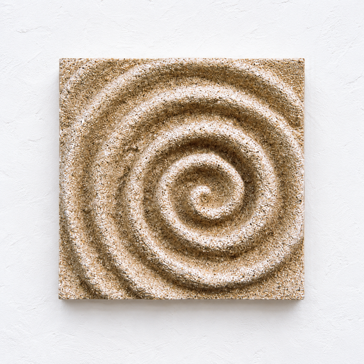 Sand-coloured square Spiral relief with a continuous textured coil against a white background.