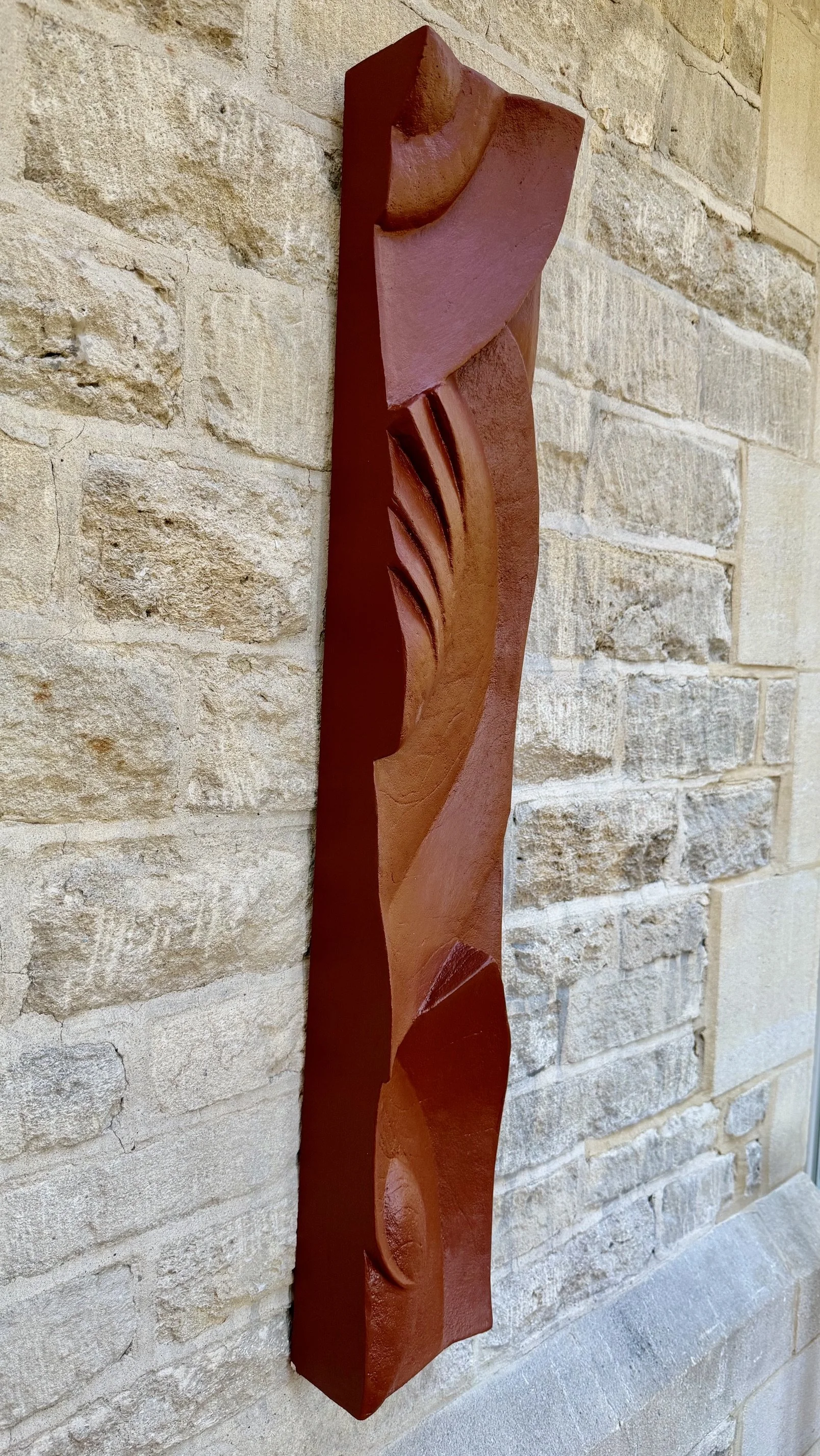 Angled view of the terracotta Decowaves 2 panel, showing its raised sweeping forms.