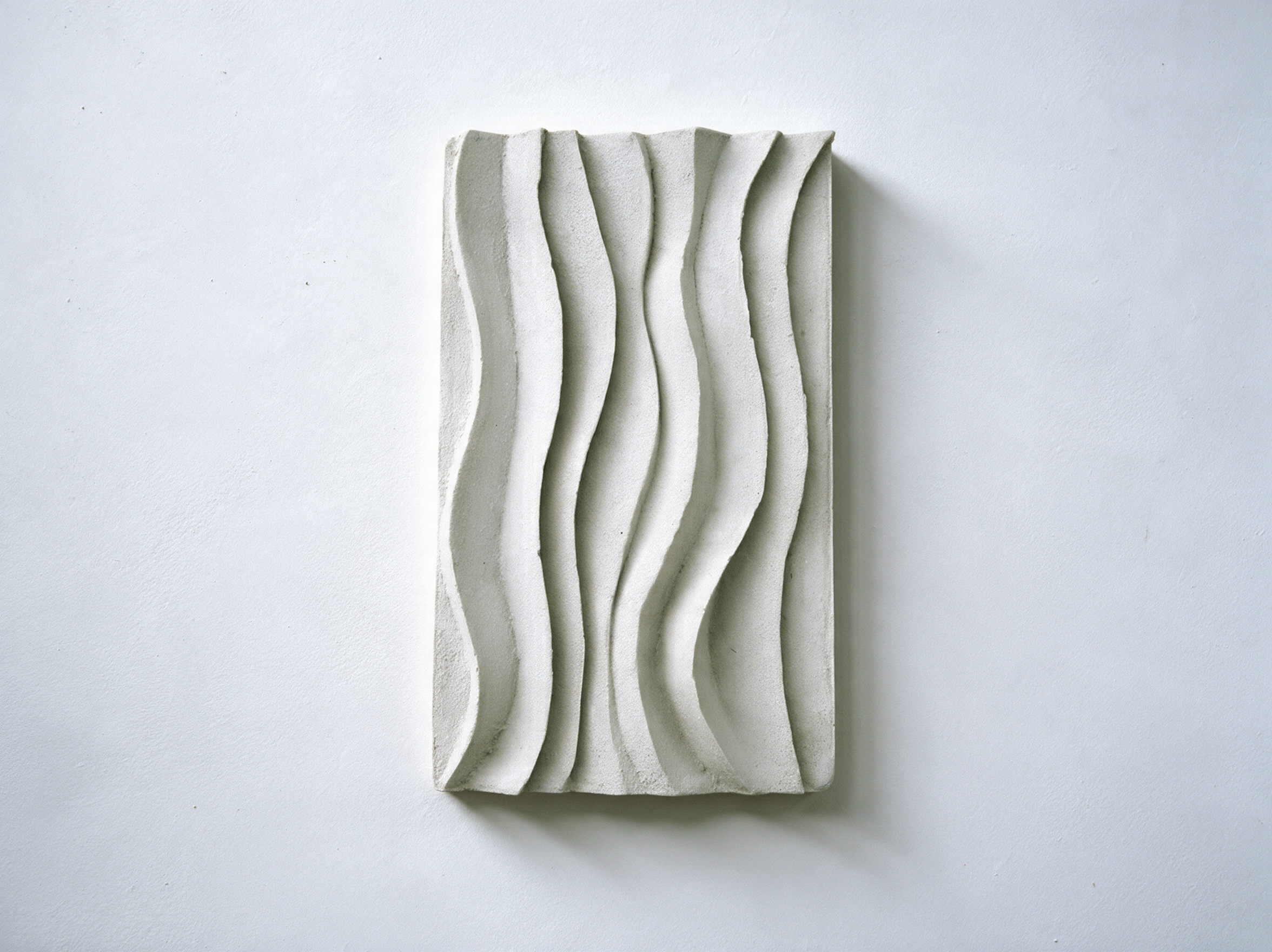 White Dune Ripple 1 relief with flowing vertical ridges against white.