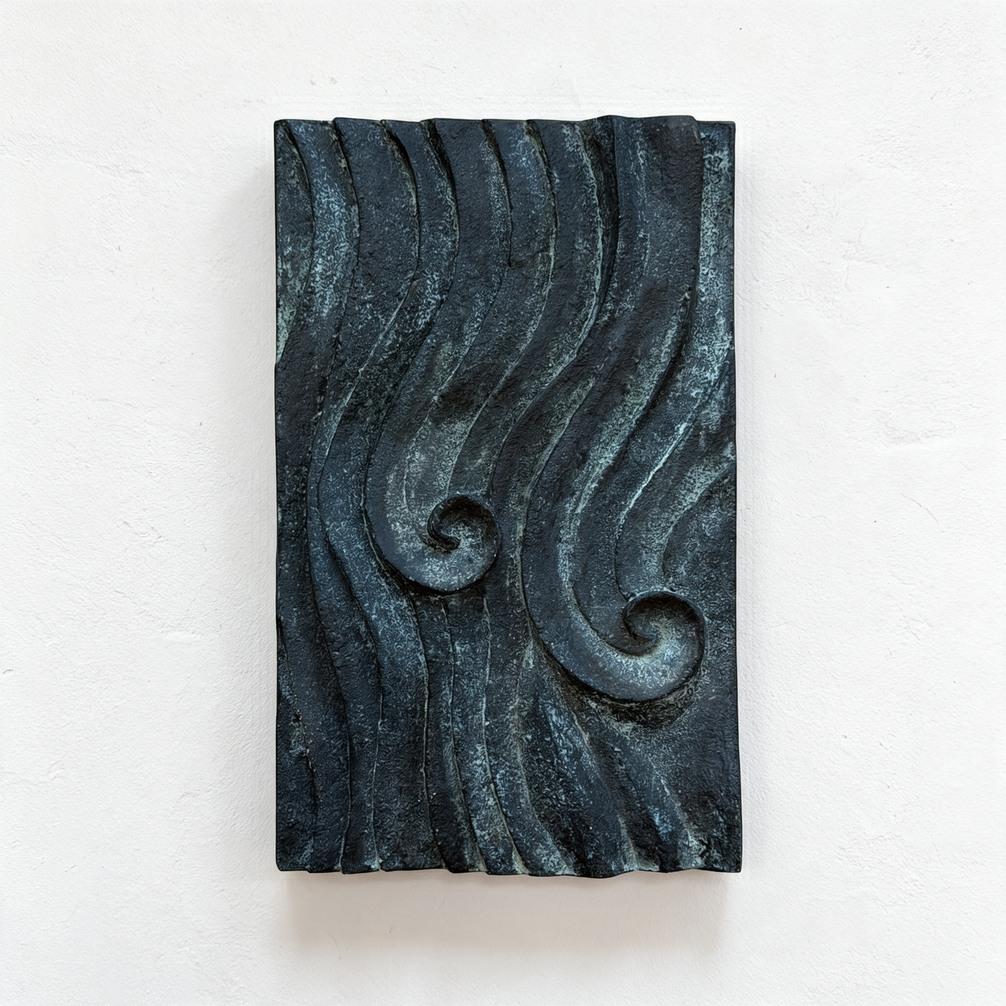 Dark bronze and verdigris Dune Ripple relief with flowing ridges and two spiral centres against white.