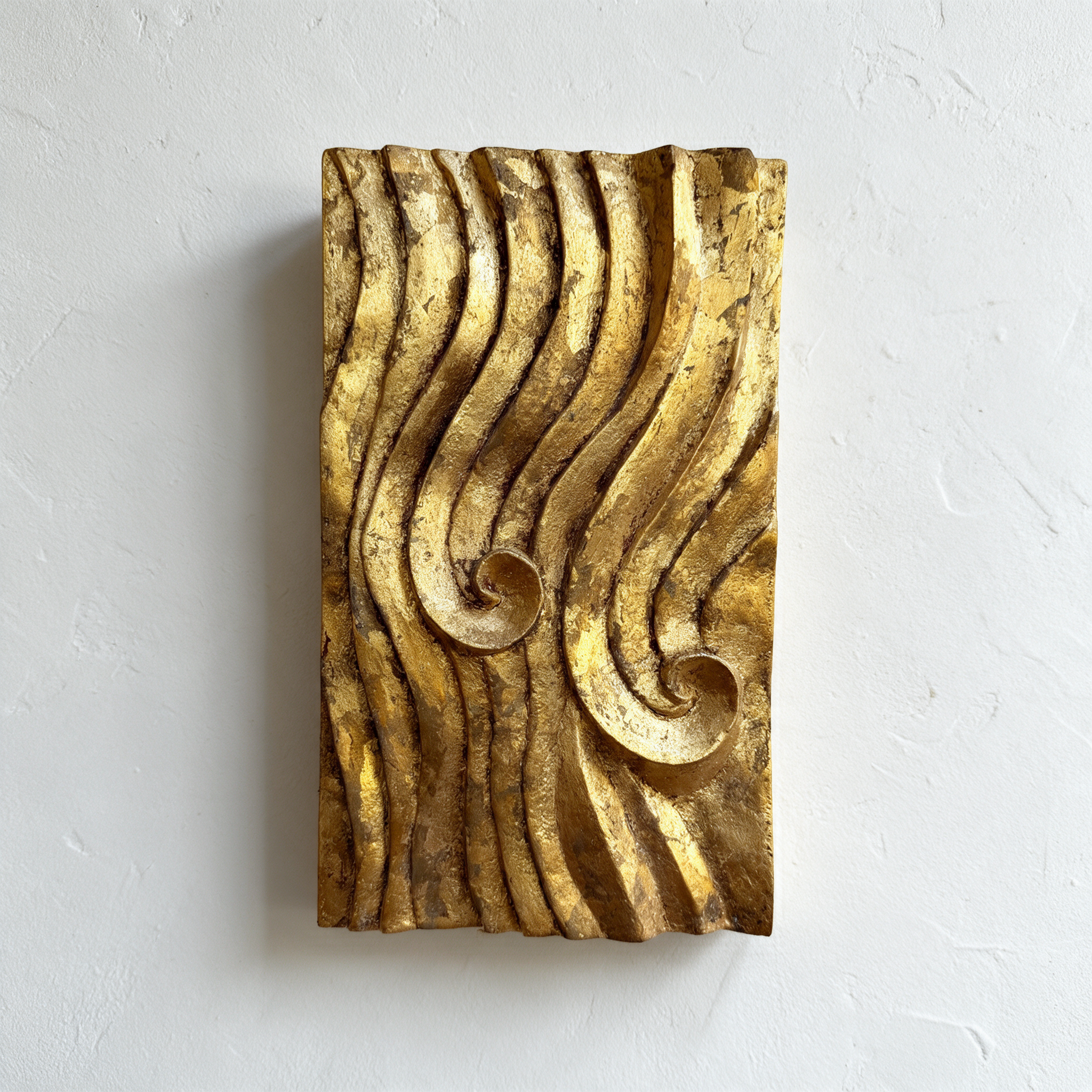 Gold-coloured Dune Ripple 2 relief with two spiral centres and dark grooves against white.