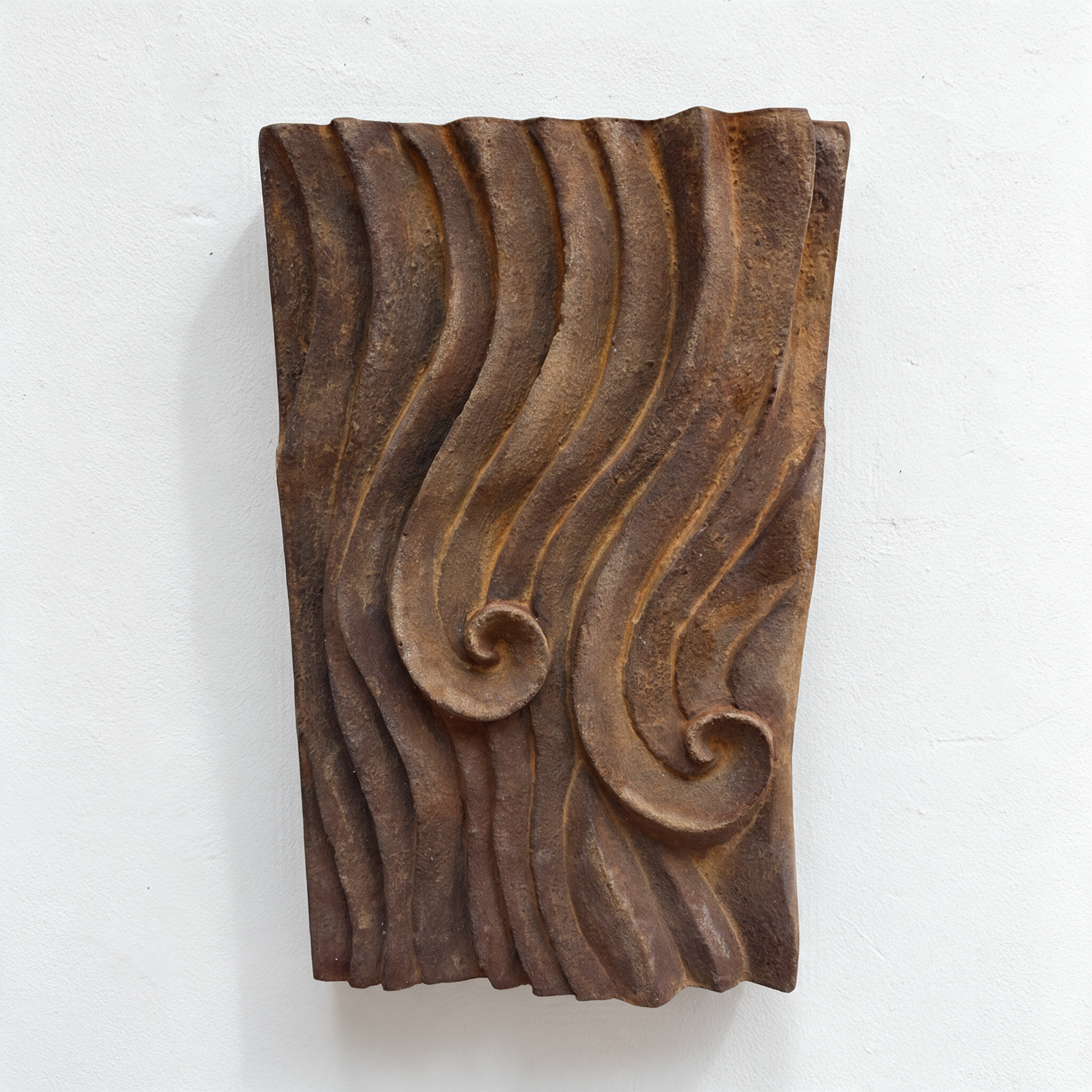 Rust-coloured Dune Ripple 2 with flowing ridges and two spirals against white.