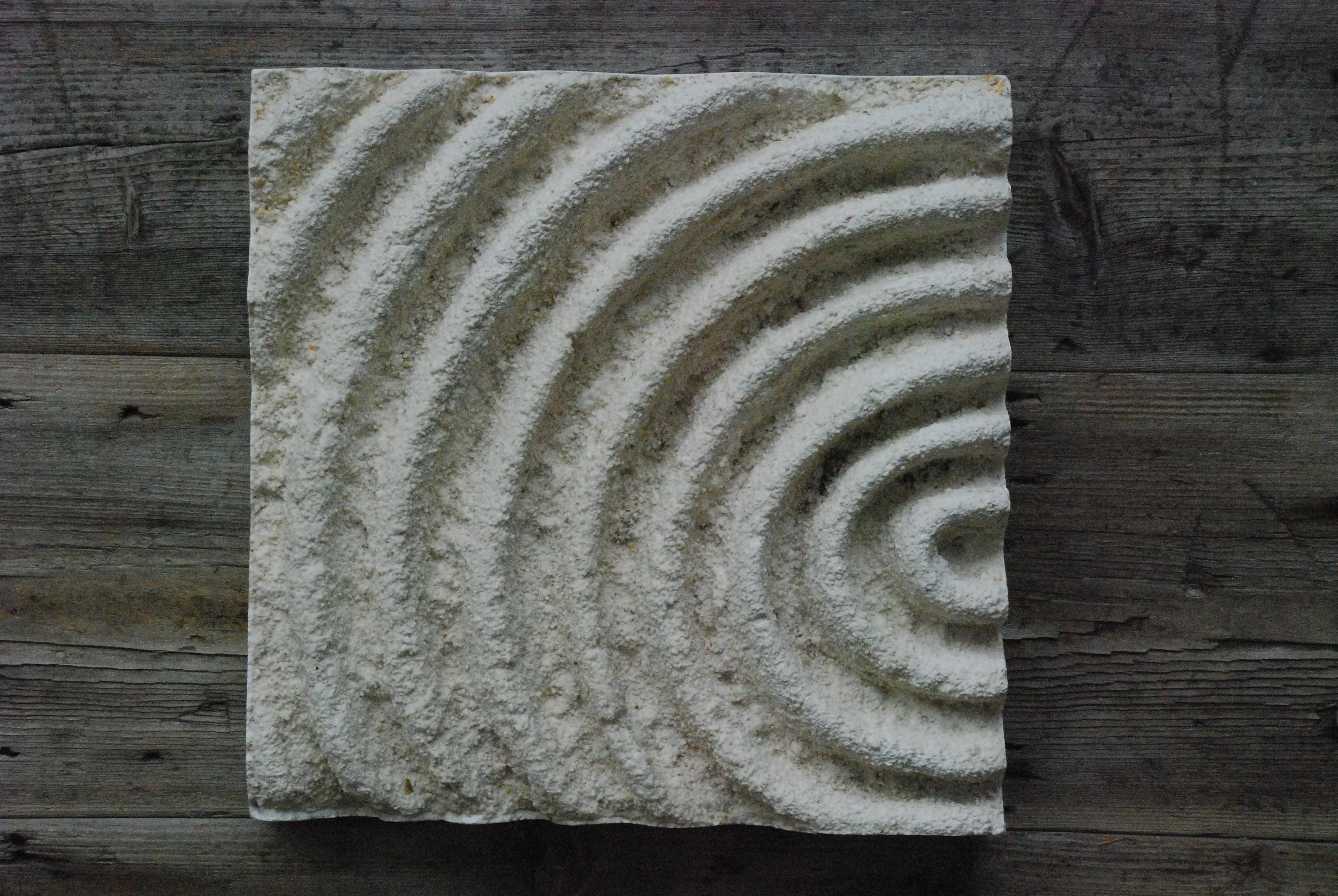 White Echo Sound 1 displayed on timber, with textured circular ridges.