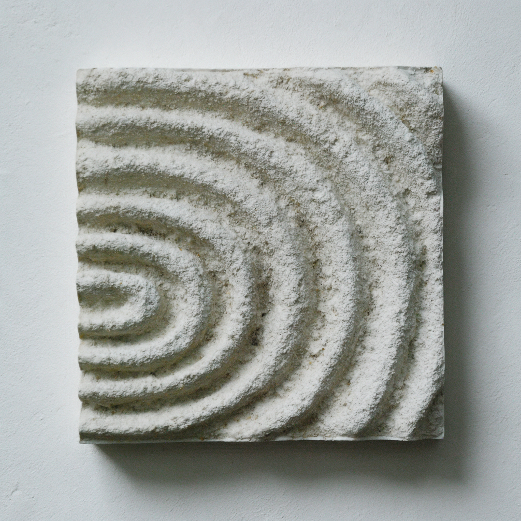 White Echo Sound 2 with textured circular ridges curving towards the left edge.
