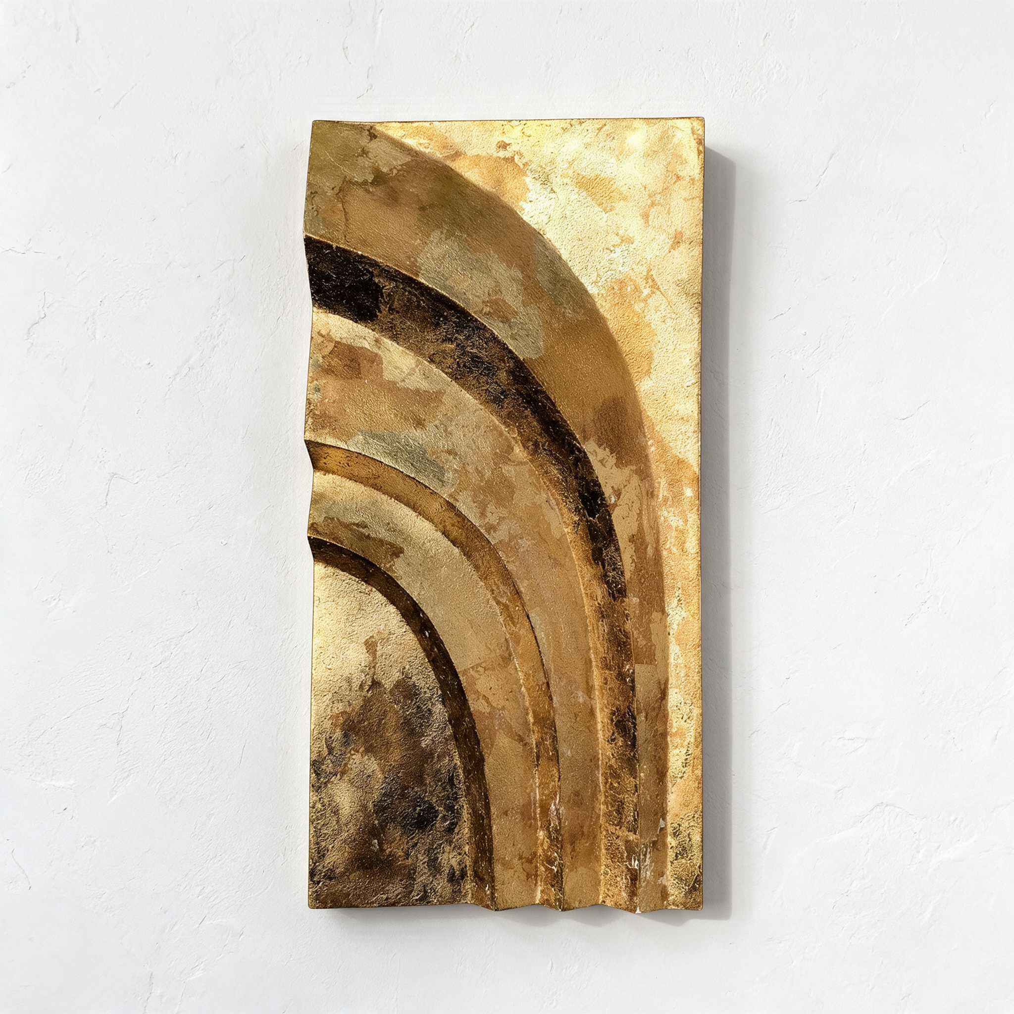 Gold-coloured Egyptian Palm 1 with sweeping curved bands against a pale wall.