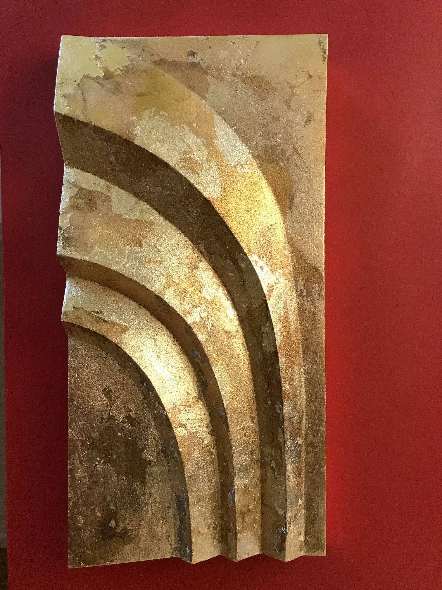 Gold-coloured Egyptian Palm 1 panel shown against a red background.