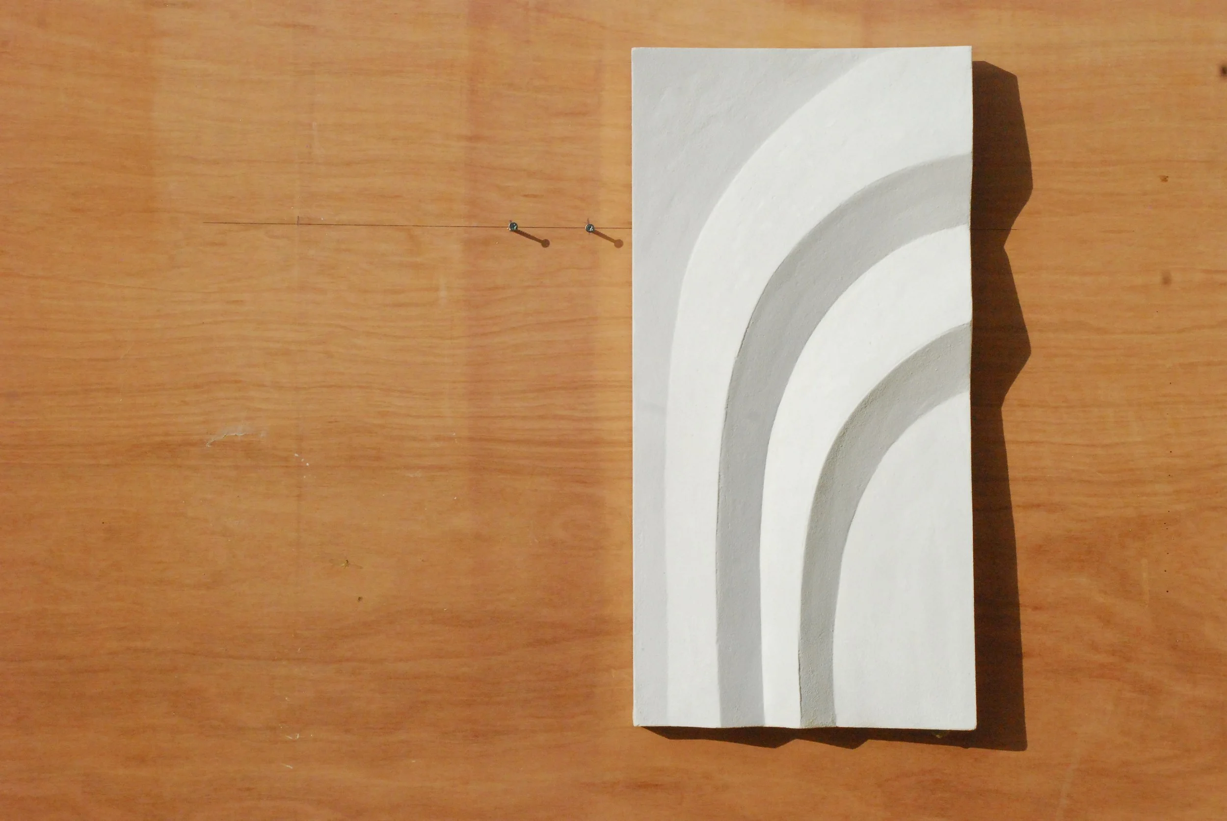 White Egyptian Palm 2 relief displayed vertically on timber.