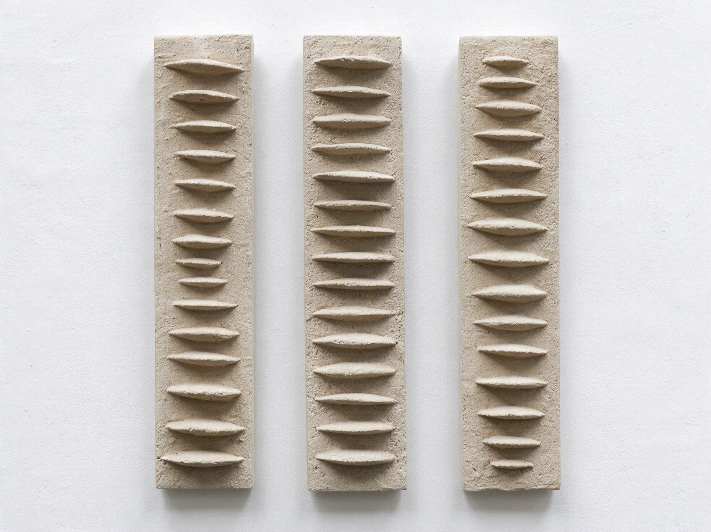 Three white Frozen Fish panels displayed side by side against a pale wall.