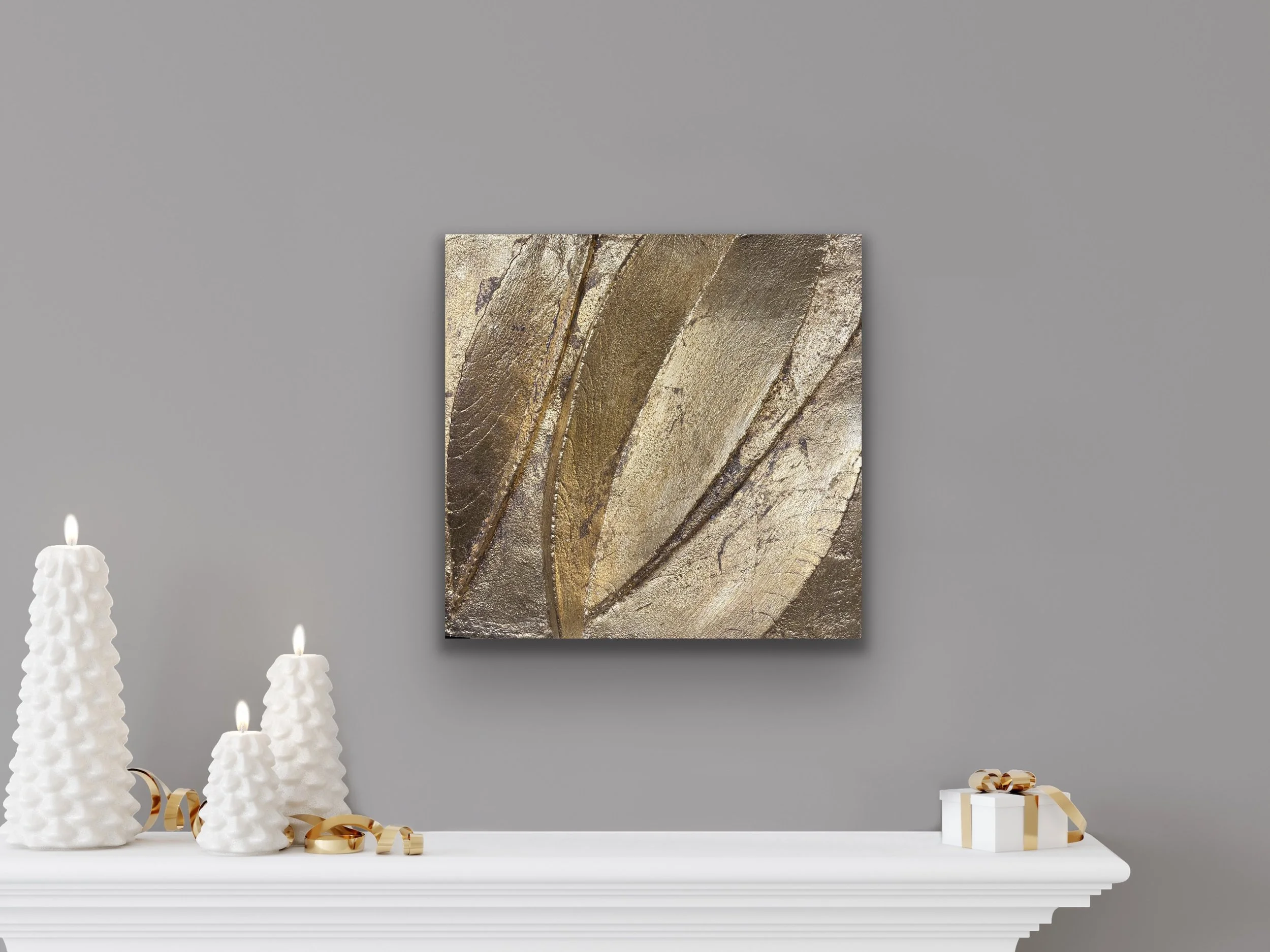 Gold-coloured Leaf Form relief displayed above a white mantel with candles and small ornaments.