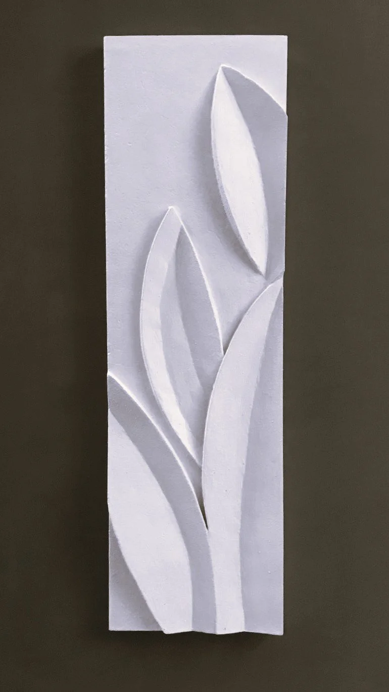 White Leaf Growth relief with pointed leaves against a dark background.