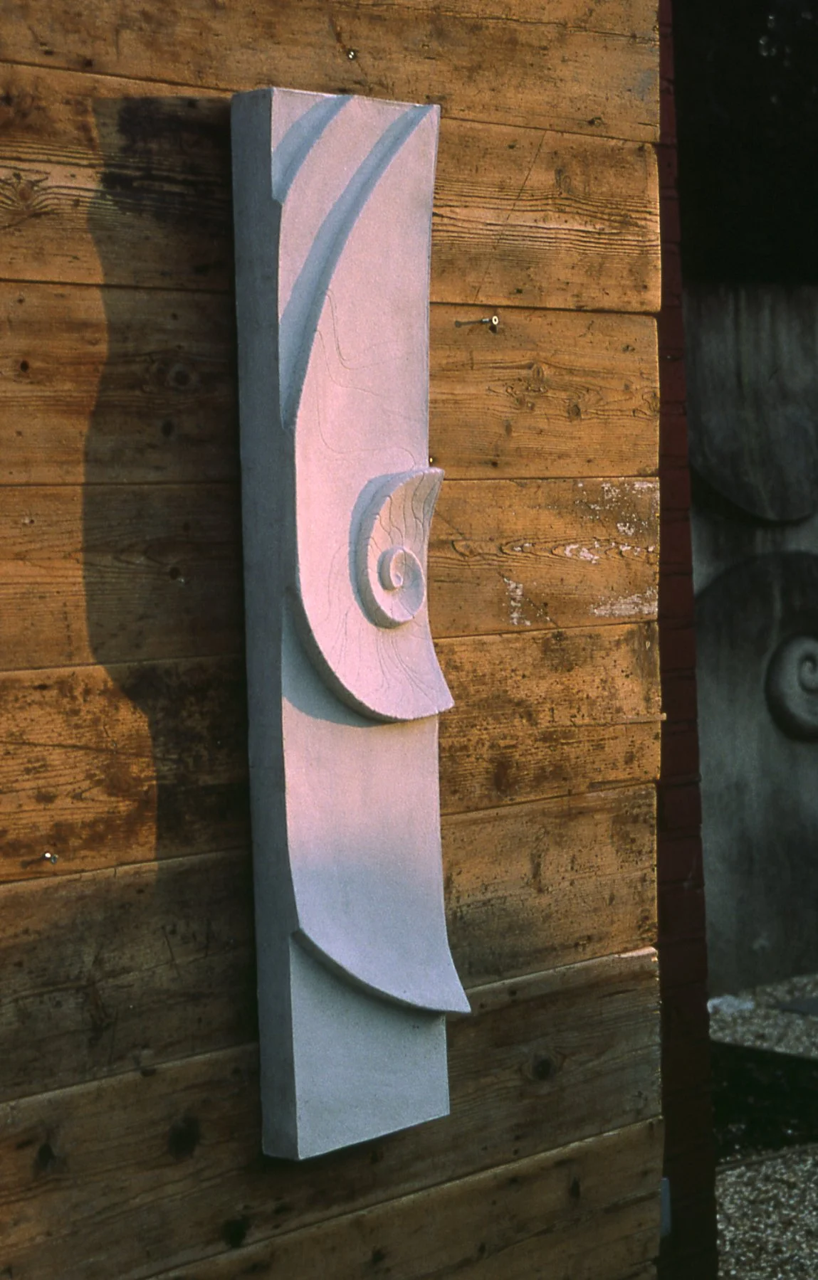 Tall white Moon and Shellwave 1 relief on timber, with a spiral centre and sweeping curves.