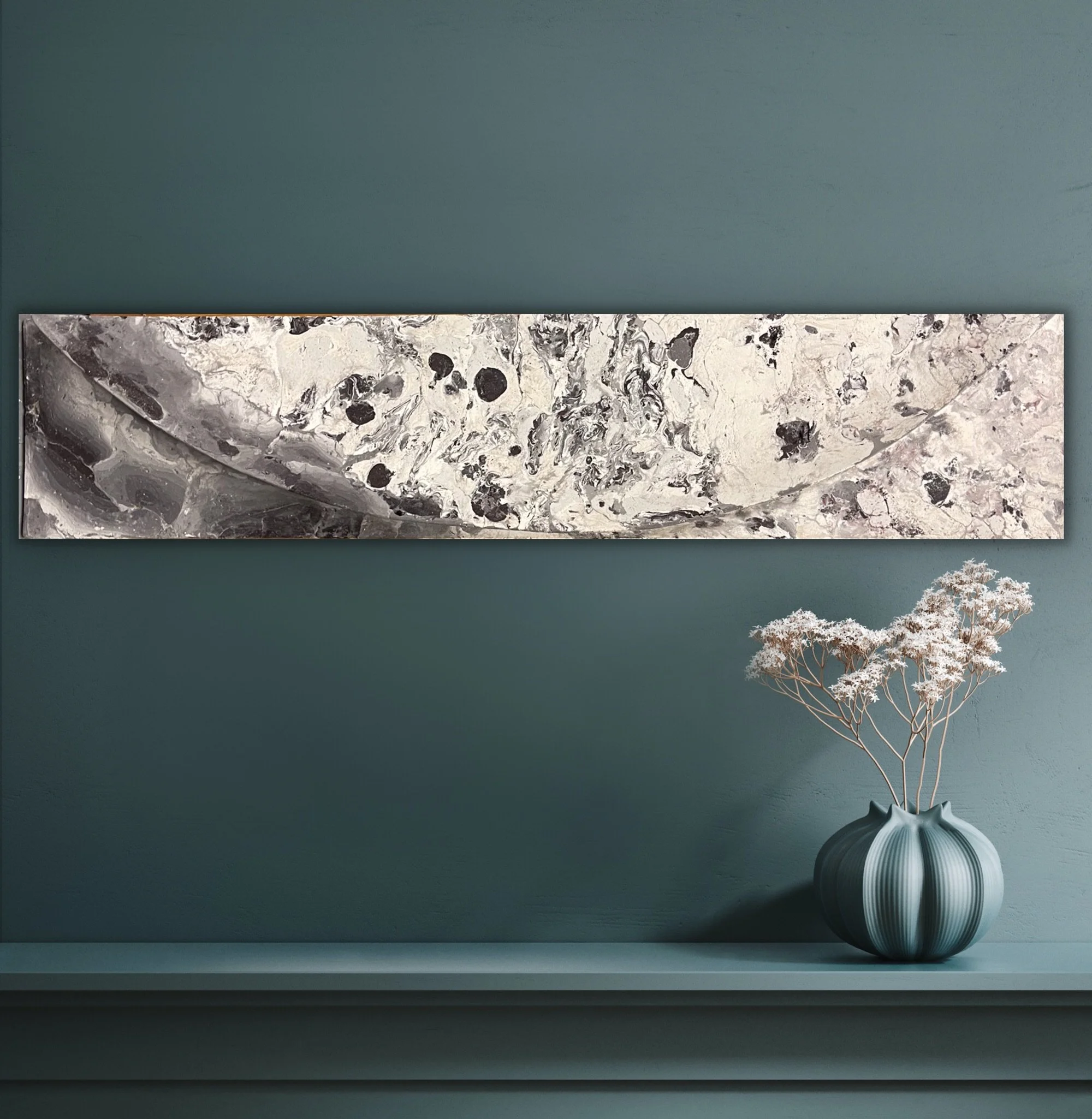 Black and white Moon and Shellwave 2 relief displayed horizontally on a dark green wall above a vase.
