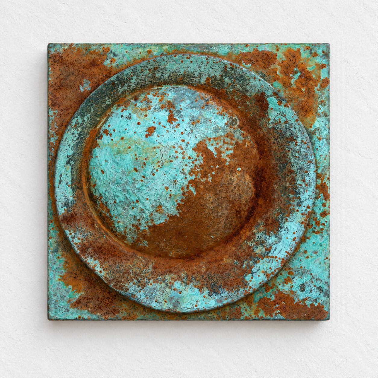 Verdigris and rust Moon Crater Phase 3 relief with a circular centre and surrounding curved band.