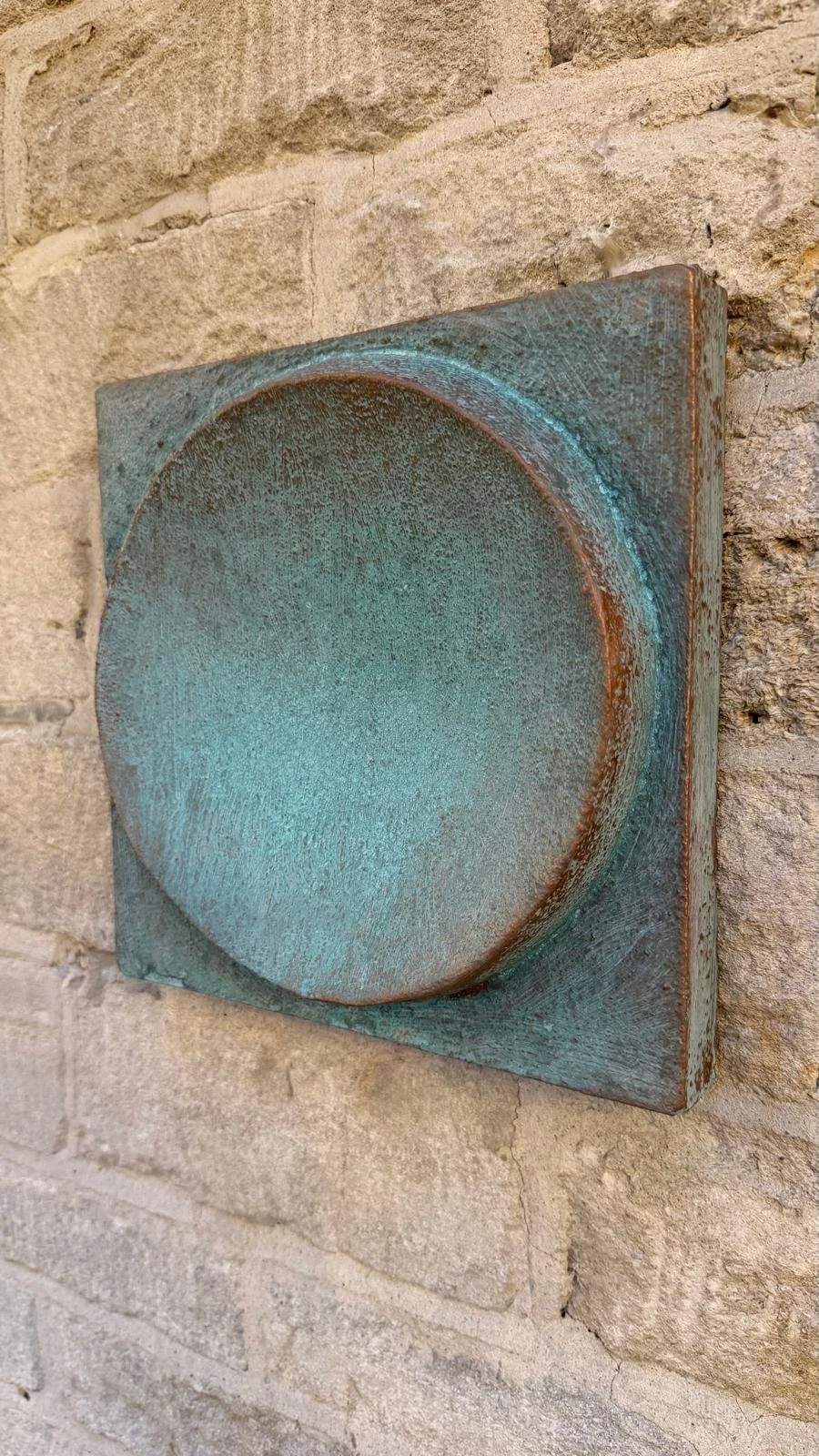 Verdigris Moon Crater Phase 4 relief mounted on stone, shown at an angle.