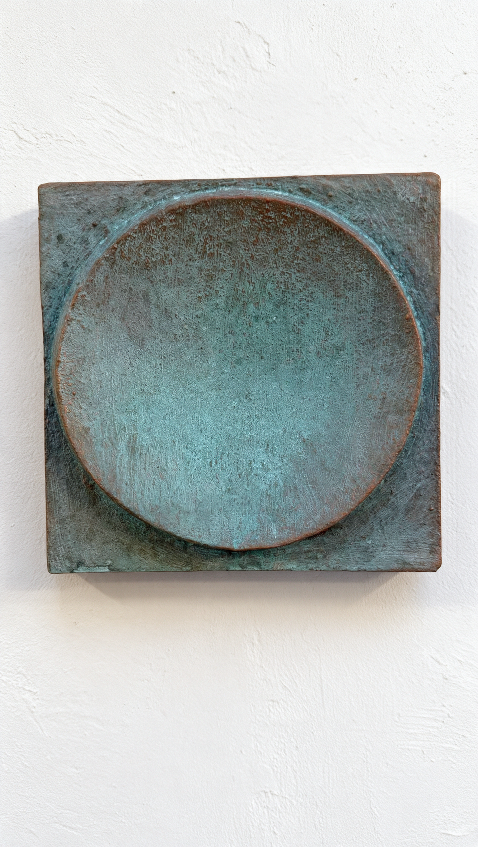 Verdigris Moon Crater Phase 4 with a turquoise circular recess and dark rim against white.