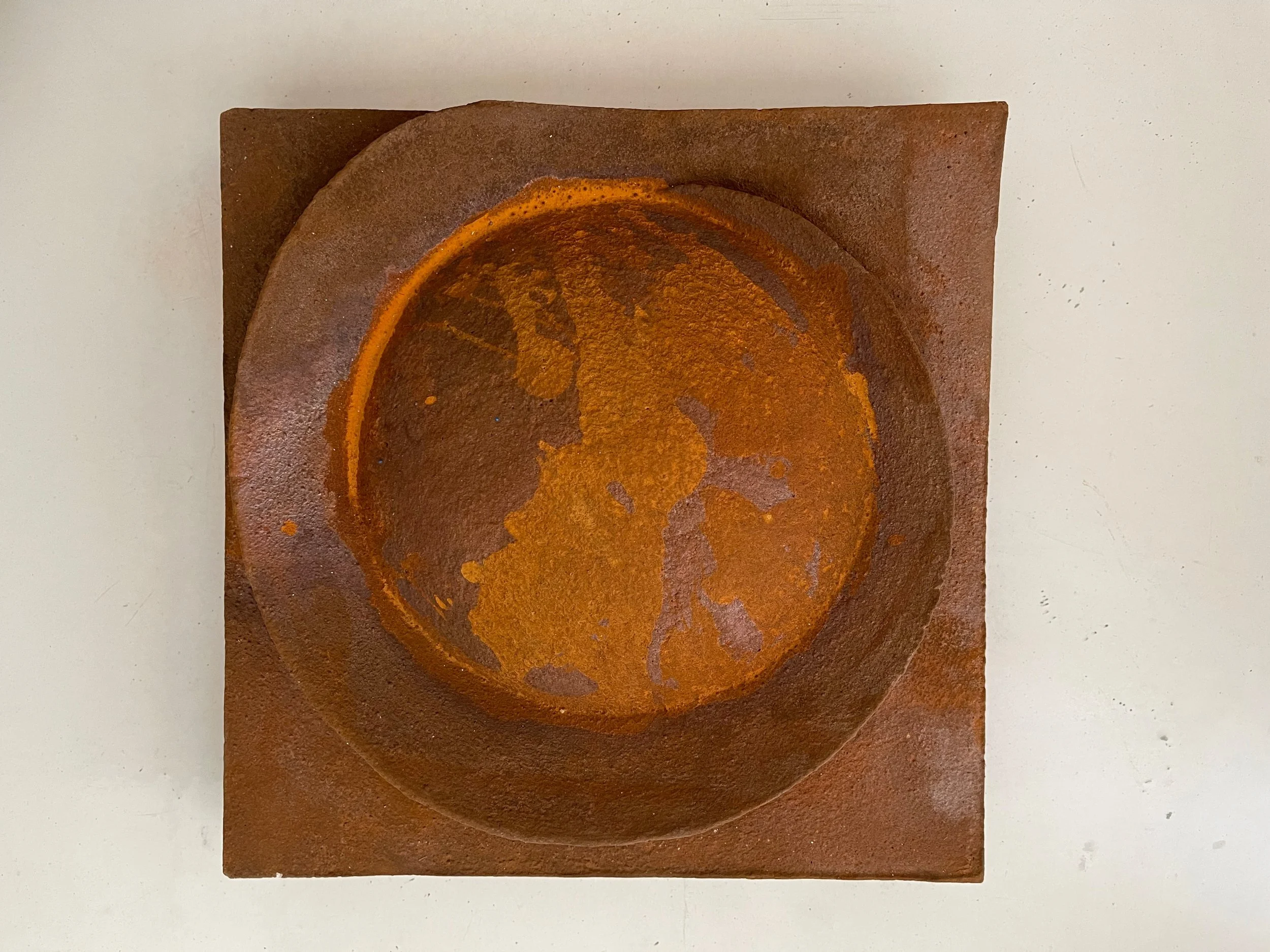 Rust-coloured Moon Crater Wide Lip Drip relief with a recessed orange and brown circular centre.