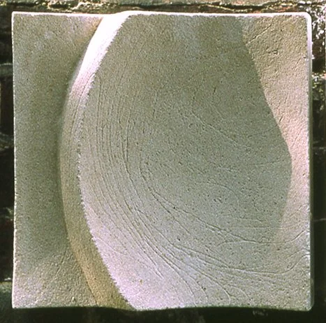 Textured white Moonphase 4 curved relief photographed in outdoor light.